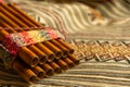 Close up view of Peruvian pan flute, on a coloured poncho. Concept of traditional Andean music Royalty Free Stock Photo