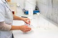 Close up view of a pharmacist in the laboratory mixing a medical ointment in a bowl