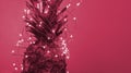 Close up view of pineapple with christmas light garland with copy space. Toned in color of year 2023 Viva Magenta.