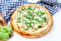 Close up view on pizza on white wooden background with ingridients. Italian cuisine. Royalty Free Stock Photo