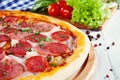 Close up view on pizza on white wooden background with ingridients. Royalty Free Stock Photo