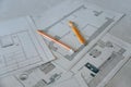 Close up view of plan of building repaiting and contruction that is on the floor with yellow pencils on it Royalty Free Stock Photo