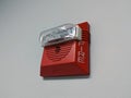 Close up view of a plastic emergency fire alarm box attached to a wall inside a business