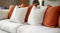 Elegant White and Burnt Orange Sofa Cushions in Modern Living Room