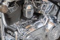 Close-up view of polishedchrome motorcycle engine components, focusing on cylinder head and heat sinks, captured from an Royalty Free Stock Photo