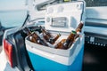 close up view of portable fridge with beer standing