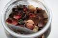 Potpourri or dried petals flowers in glass jar used for aromatherapy. Royalty Free Stock Photo