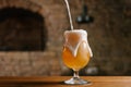 close-up view of pouring fresh cold beer with foam into glass in bar Royalty Free Stock Photo