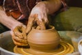 Close up view - professional male potter making pot in pottery workshop Royalty Free Stock Photo