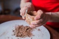 Close up view: potter shaping dry clay cup with special tool in pottery workshop