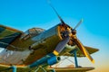 Propeller blades of the engine of an old aircraft with part of the fuselage, cabin and wings in khaki green colors Royalty Free Stock Photo