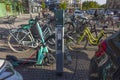 Close up view of public parking and charging place for bicycles and scooters. Cityscape view. Transportation and technology.