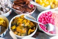 Close-up view of pumpkin slices in syrup and various other colorful sweets