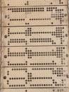 Close up of punched cards on old working hand weaving loom Royalty Free Stock Photo
