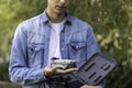 Close-up view of a quadricopter drone in selective focus view next to its travel briefcase in the hands of a young boy Royalty Free Stock Photo