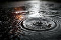 Close-up view of raindrops creating ripples on a dark surface, with reflections of light in the water, capturing the essence of a Royalty Free Stock Photo