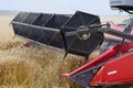 Close up view of the raised cutting head of a Massey Ferguson combine harvester Royalty Free Stock Photo