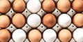 Close-up view of raw chicken eggs in egg box on white wooden background Royalty Free Stock Photo