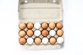 Close-up view of raw chicken eggs in egg box on white wooden background Royalty Free Stock Photo