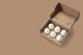 Close-up view of raw chicken eggs in egg box on white wooden background Royalty Free Stock Photo