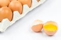 Close-up View Of Raw Chicken Eggs In Egg Box On White Wooden Background.