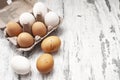 Close-up view of raw chicken eggs in egg box on white wooden background Royalty Free Stock Photo