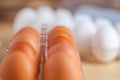 Close-up view of raw chicken eggs in egg box on wooden background Royalty Free Stock Photo