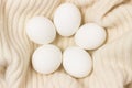 Close Up View Of Raw Chicken Eggs In Shell On White Woolen Background
