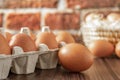 Close-up view of raw chicken eggs on wooden background. Fresh farm egg. eggs in carton box. Royalty Free Stock Photo