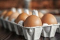 Close-up view of raw chicken eggs on wooden background. Fresh farm egg.