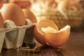 Close-up view of raw chicken eggs on wooden background. Fresh farm egg. Eggs in carton box. Royalty Free Stock Photo