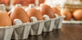 Close-up view of raw chicken eggs on wooden background. Fresh farm egg. eggs in carton box. Royalty Free Stock Photo