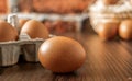 Close-up view of raw chicken eggs on wooden background. Fresh farm egg. eggs in carton box. Royalty Free Stock Photo