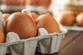 Close-up view of raw chicken eggs on wooden background. Fresh farm egg. eggs in carton box. Royalty Free Stock Photo