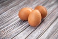 Close-up View Of Raw Chicken Eggs On Wooden Background.