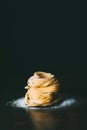 close up view of raw tagliatelle pasta and flour on table