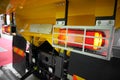 Close up view on rear car tipper truck red and yellow light with silver metal protective cover housing. Commercial transport indus Royalty Free Stock Photo