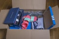 Close up view of received home delivery box with fashionable, sports, various shoes.