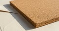 A close-up view of a rectangular sheet of cork board placed on a light-colored surface. Royalty Free Stock Photo