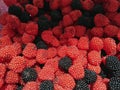 Close up view of red and black colors gummy fruit jelly ball in sugar, Candy background