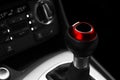 Close up view of a red gear lever shift. Manual gearbox. Car interior details. Car transmission. Soft lighting. Abstract view. Car Royalty Free Stock Photo