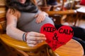 Pregnant woman and red valentine heart