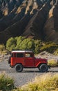 Close up view of red jeep with Bromo volcano background