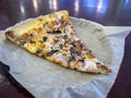 Close up view of a red onion and mushroom vegetarian pizza on a plate inside a small local pizza joint Royalty Free Stock Photo