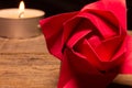 Close up view of a red paper rose with a tea light on a black background with copy space Royalty Free Stock Photo