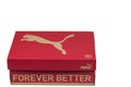 Close up view of red shoe box with Puma logo isolated on white background.