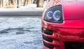 Close-up view of red sports car headlight