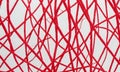 close-up view red string pattern on white background, with the strings arranged in diagonal grid-like pattern. Royalty Free Stock Photo