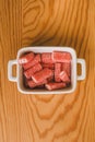 Close up view of red sugary candy on wooden background. Jelly sweets in a bowl. Royalty Free Stock Photo