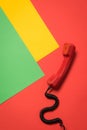 Close-up view of red telephone receiver with curly cord Royalty Free Stock Photo